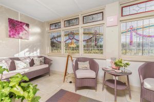 Front sunroom with views through the leadlight windows to Oxley hill.