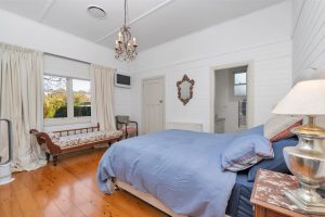 Main bedroom with ensuite and picture window overlooking the main garden. French doors to deck.