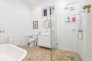 Main bathroom with radiator and heated towel rail.