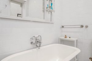 Main bathroom with bath and shower.